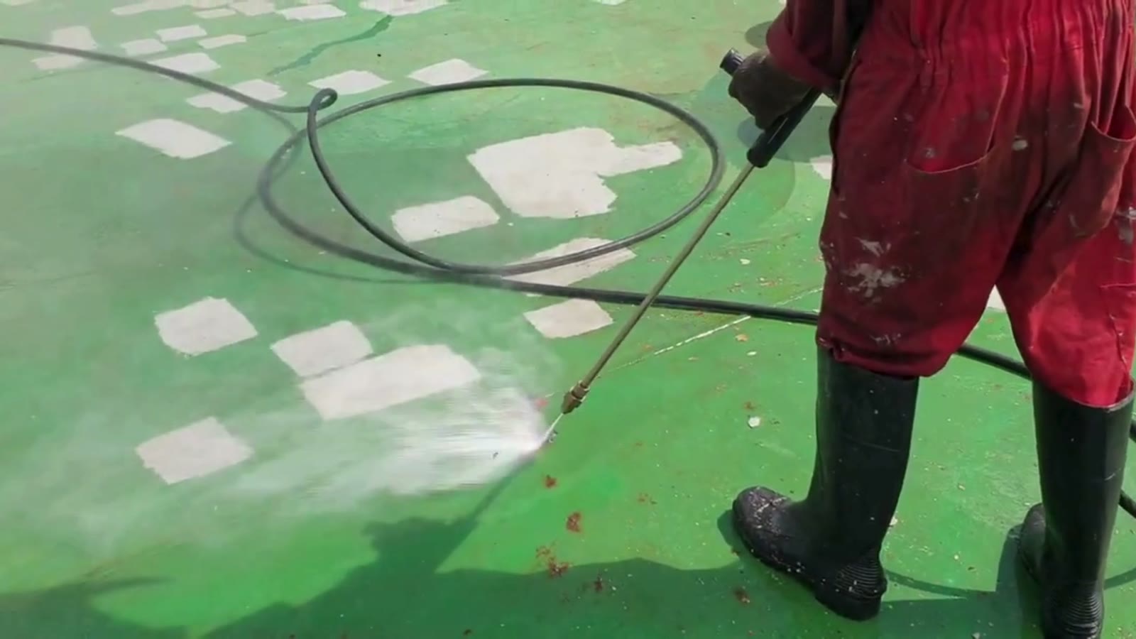 High-pressure water jetting stripping coating from steel