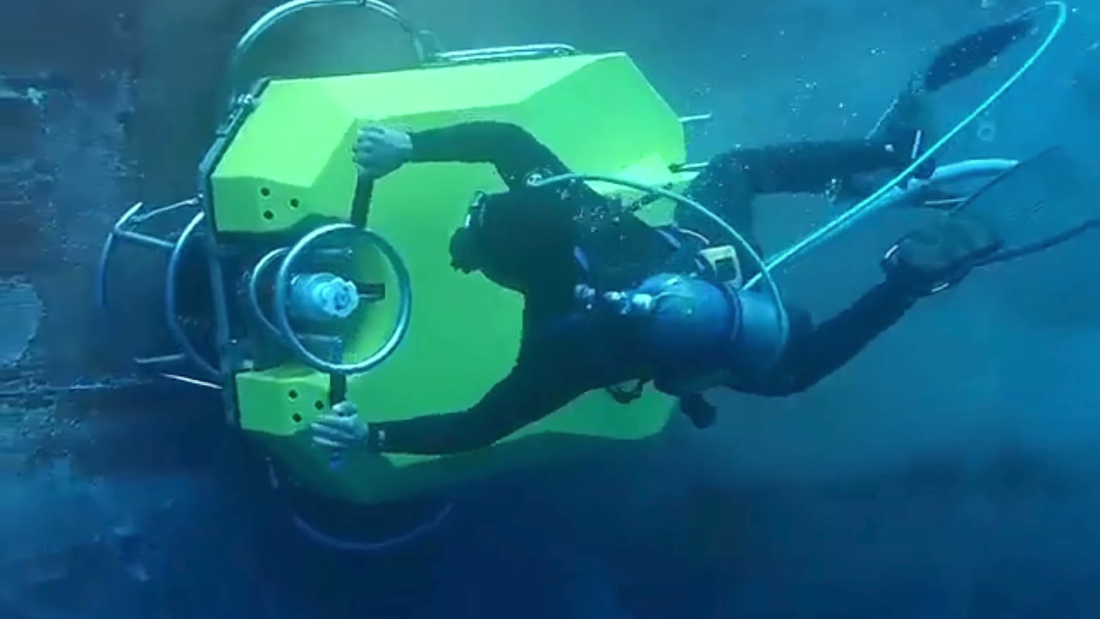 Diver cleaning marine growth from a vessel's underwater hull